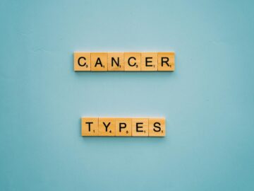 Wooden letter tiles spelling 'Cancer Types' on a blue background.