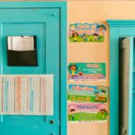 Vibrant kindergarten wall with educational posters and blue door.