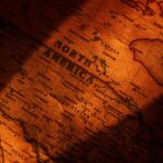 Close-up view of a vintage styled map showing North America with dramatic lighting.