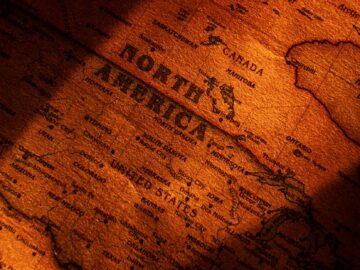 Close-up view of a vintage styled map showing North America with dramatic lighting.