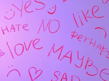 Pink handwritten words like love, hate, and maybe on a gradient background.