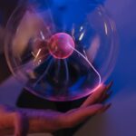 A mesmerizing plasma ball generating colorful electric arcs in a dark room, creating a scientific and futuristic vibe.