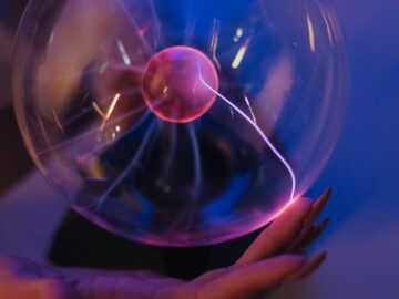 A mesmerizing plasma ball generating colorful electric arcs in a dark room, creating a scientific and futuristic vibe.