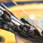 Close-up of colorful paintbrushes in a creative and artistic setting, evoking a lively studio atmosphere.