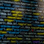 An extreme close-up of colorful programming code on a computer screen, showcasing development and software debugging.