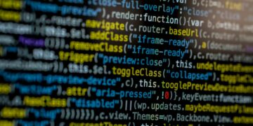 An extreme close-up of colorful programming code on a computer screen, showcasing development and software debugging.