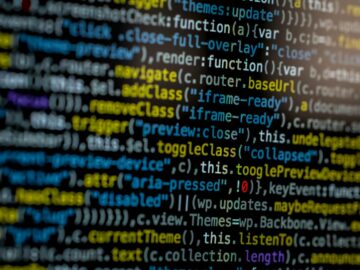 An extreme close-up of colorful programming code on a computer screen, showcasing development and software debugging.