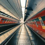 Contemporary underground escalator tunnel showcasing modern architecture and steel design.
