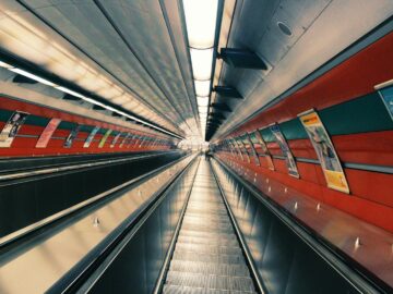 Contemporary underground escalator tunnel showcasing modern architecture and steel design.