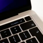 High-resolution close-up of a laptop keyboard featuring a 'Try Again' button.