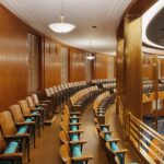 Captivating view of a government chamber with elegant wood paneling and seating arrangement in Bismarck, ND.