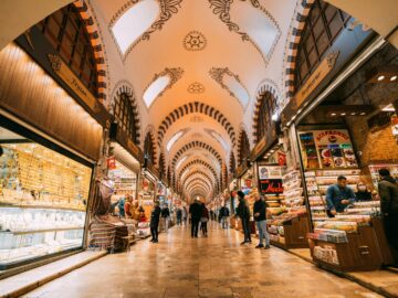 Vibrant scene inside the Grand Bazaar, filled with shops and people exploring traditional goods.