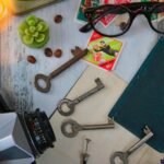 A creative flat lay featuring vintage items like a camera, old keys, and colorful stamps.