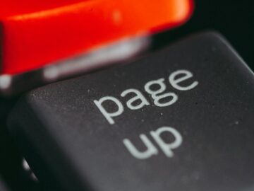 Close-up macro photography of a keyboard's 'page up' key, highlighting its texture and design.
