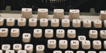 Detailed close-up of a vintage typewriter keyboard showcasing retro design.
