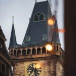 A captivating image of Prague's iconic clock tower with warm evening lights.