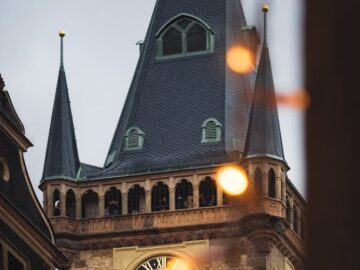 A captivating image of Prague's iconic clock tower with warm evening lights.