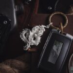 Stylish flat lay of a luxury car key with an ornamental dragon keychain, perfect for automotive themes.