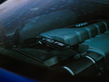 Detailed view of a powerful V10 FSI sports car engine under glass.