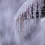 Close-up view of icicles formed on a roof edge during winter.