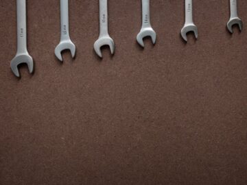 Top view of wrenches lined up on a textured brown surface, showcasing sizes.