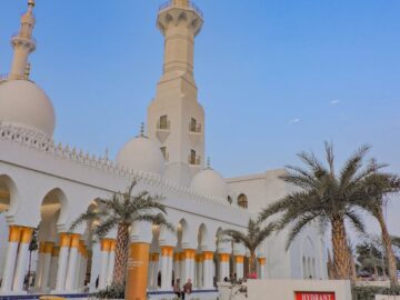 A stunning view of a mosque with tall minarets and intricate architecture during dusk, reflecting spiritual elegance.