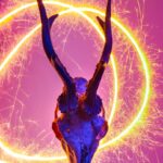 Deer skull with glowing horn illumination and vibrant sparklers.