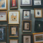 Collection of framed art and illustrations displayed on a gallery wall.