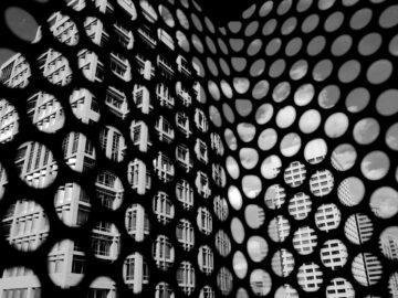 Abstract reflection pattern of a modern building in Phoenix captured through perforated metal.