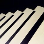 Creative abstract pattern resembling piano keys or stairs in black and white tones.