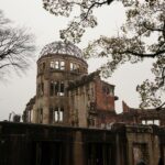Hiroshima Peace Memorial with bare trees represents history and resilience.