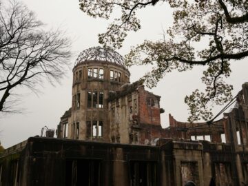 Hiroshima Peace Memorial with bare trees represents history and resilience.