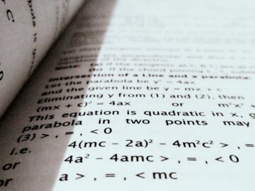 A close-up shot of mathematical equations on a book page, perfect for education and learning concepts.