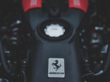Focused view of a red Ferrari engine showcasing automotive engineering and power.