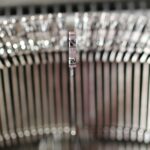 Detailed view of a vintage typewriter arm, showcasing classic mechanical design.