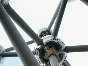 Close-up view of an iconic steel structure with metallic spheres and connecting rods.