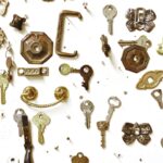 Assorted vintage keys and hardware showcased on a white background, highlighting intricate designs.