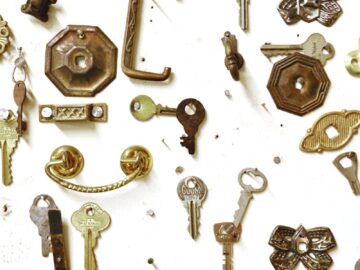 Assorted vintage keys and hardware showcased on a white background, highlighting intricate designs.