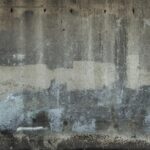 A close-up of a textured concrete wall showcasing painted layers in Avila Beach, CA.