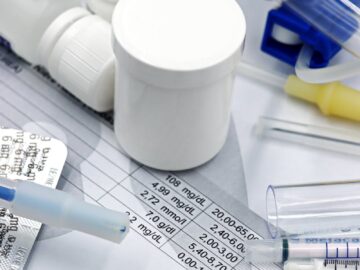 Close-up of medical supplies and test results related to veterinary care and pet health.