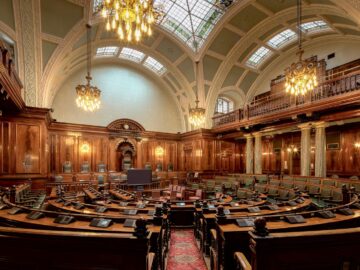 A beautifully designed chamber room with ornate woodwork and chandeliers in the UK.