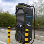A state-of-the-art electric vehicle charging station situated outdoors in a public area.