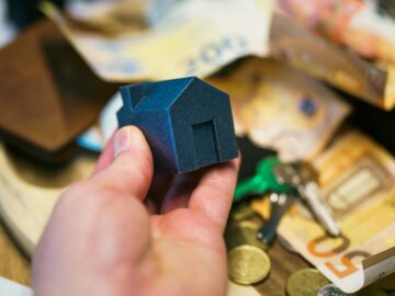 hand hold real estate residential 3d model banknotes door key background