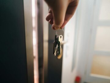 door key hand holding new house real estate market home interior