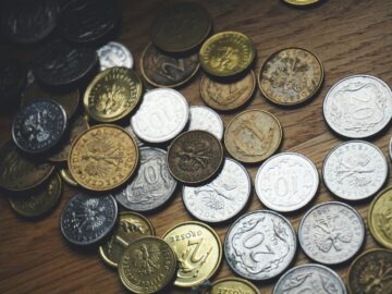 Close-up view of various Polish coins on a wooden table showcasing currency and finance concepts.