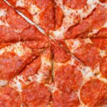 Close-up of a cheesy pepperoni pizza with mouth-watering toppings.