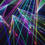 Dynamic multicolor laser beams create an electrifying display in a nighttime laser show.