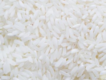 A detailed close-up shot showcasing a generous amount of white rice grains, ideal for culinary themes.