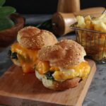 From above of appetizing burgers with golden buns and melted cheddar cheese for lunch