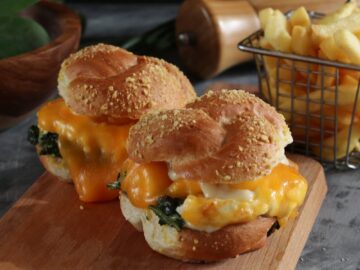 From above of appetizing burgers with golden buns and melted cheddar cheese for lunch